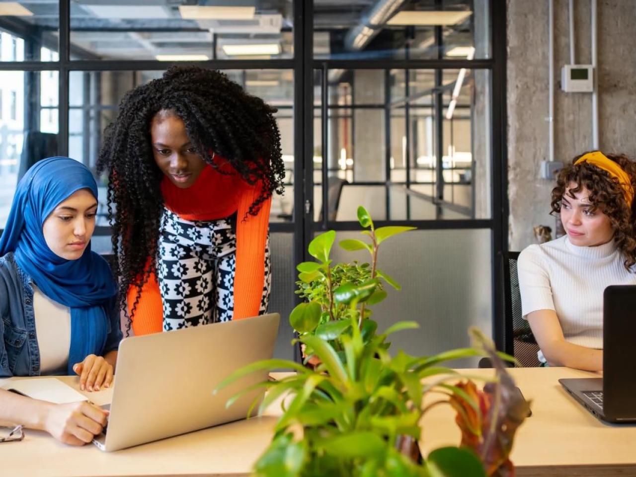 diverse women working on laptops