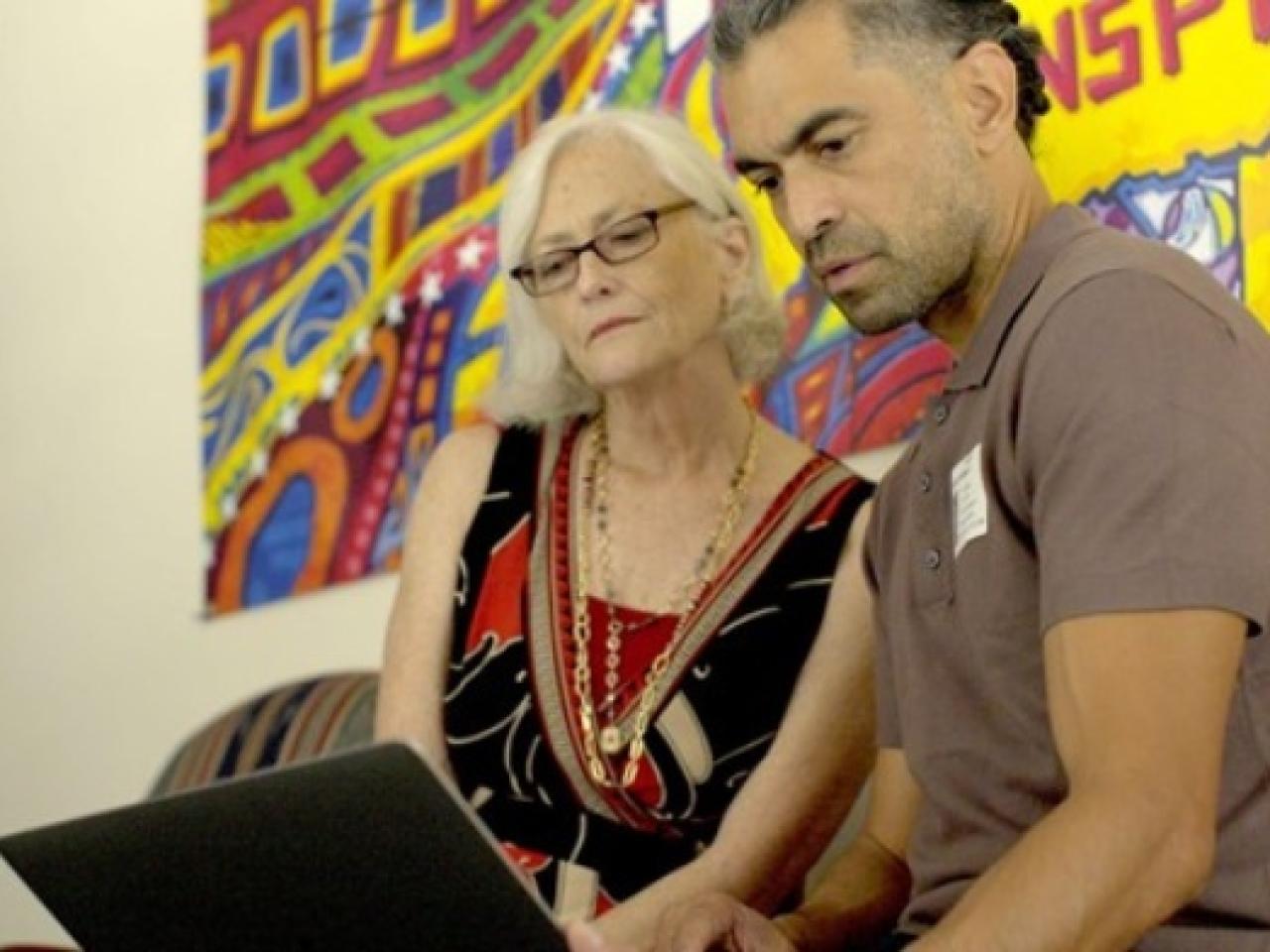 People looking at a laptop screen